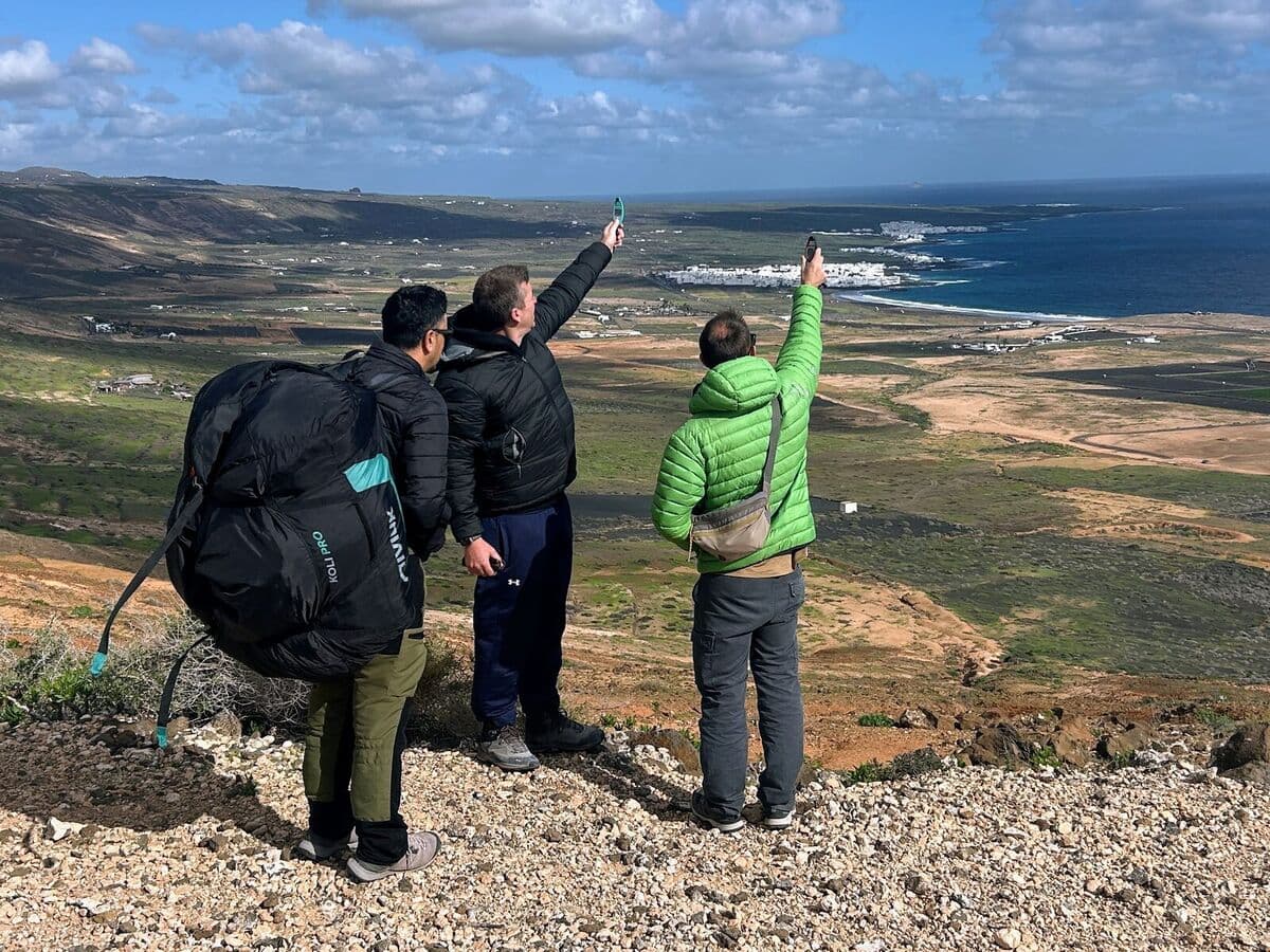 Two paragliding pilots reading the wind on-site at the Mala launch in Lanzarote